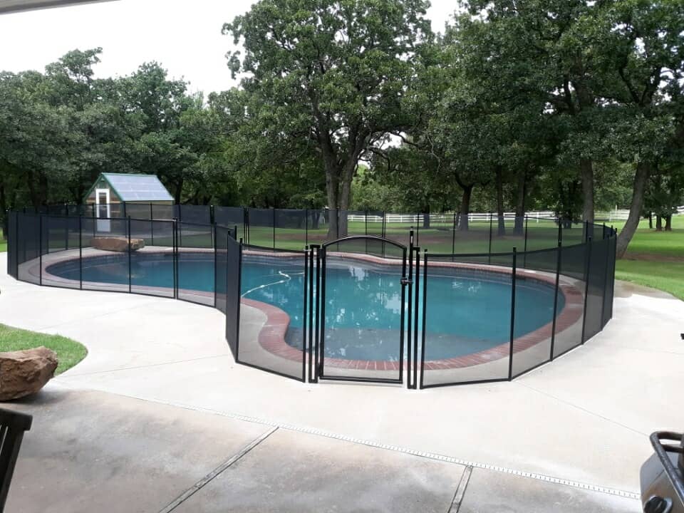 black mesh fence installed with self-locking pool gate in Edmond, OK