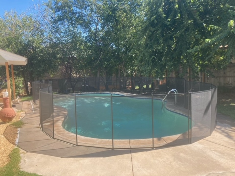 removable mesh pool fence with solid core pole installed in Edmond, OK